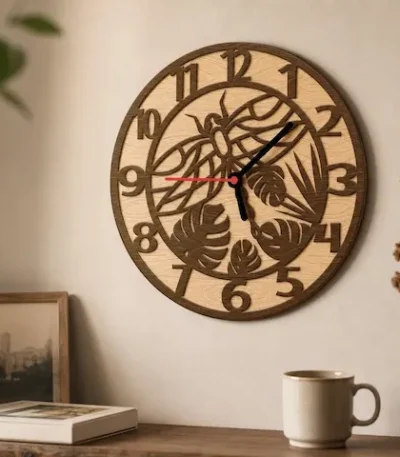 Round wooden wall clock with dragonfly and tropical leaf cutout design