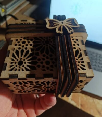 Laser cut wooden gift box with geometric pattern and bow