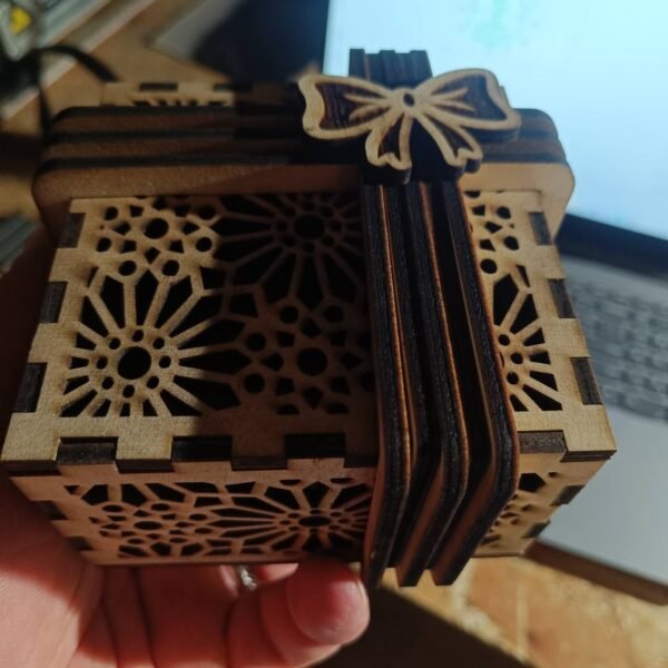 Laser cut wooden gift box with geometric pattern and bow
